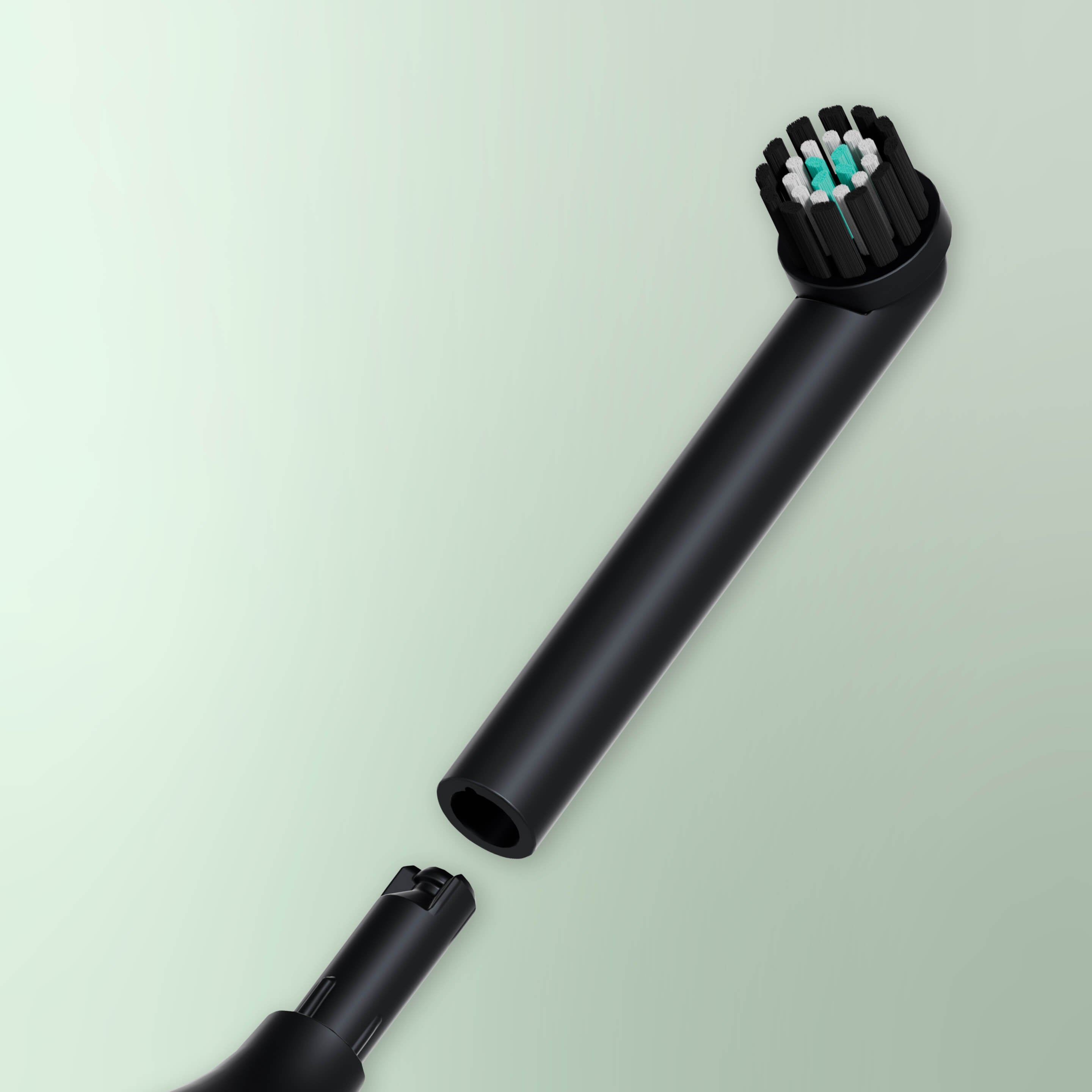 A black quip Rev brush head refill detached from the main body of a black quip electric toothbrush, against a light green background.