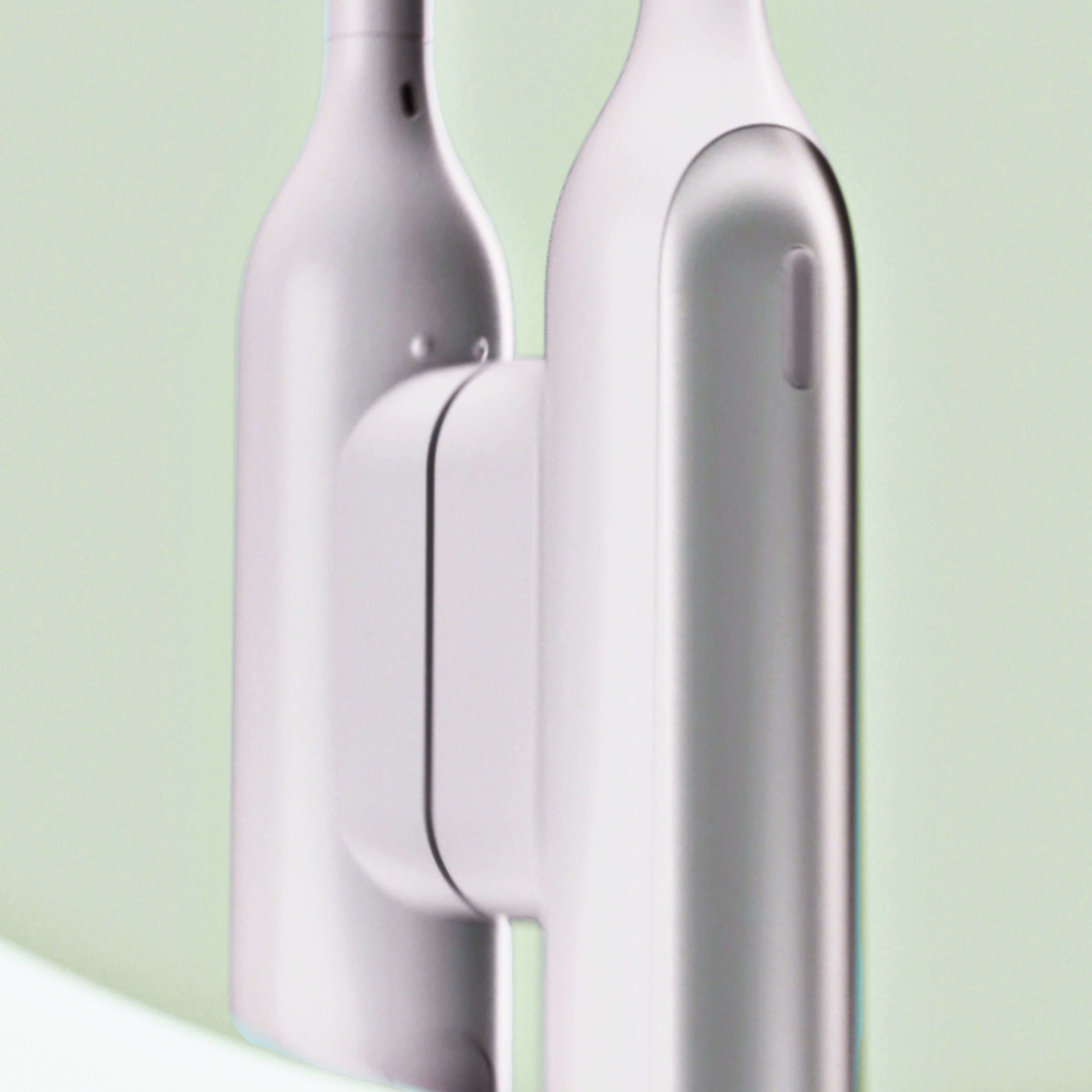 Rev oscillating toothbrush attached to a white Rev mirror mount, shown close-up against a soft light green background.