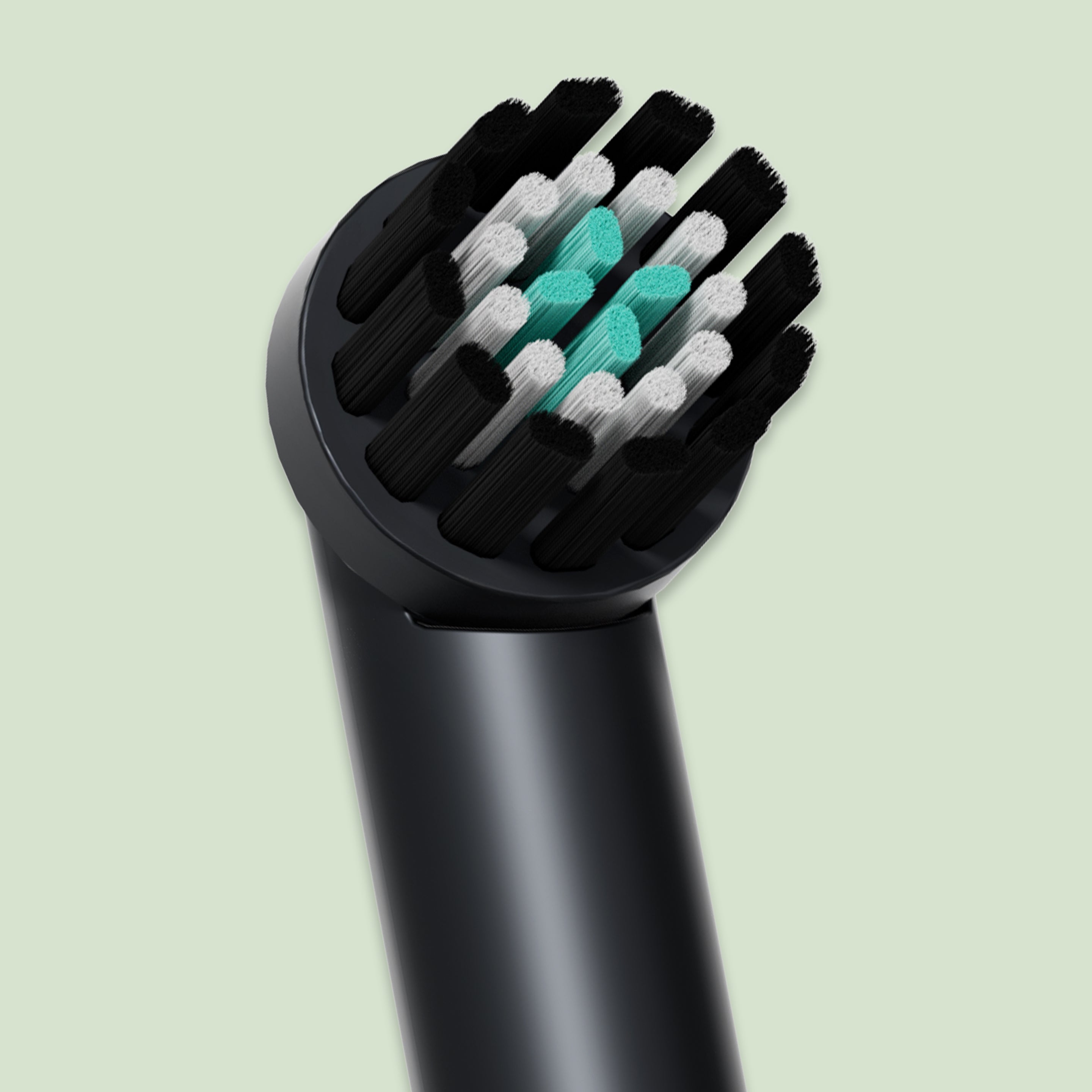 Close-up of the Rev Oscillating Toothbrush replacement head with black, white, and teal bristles.