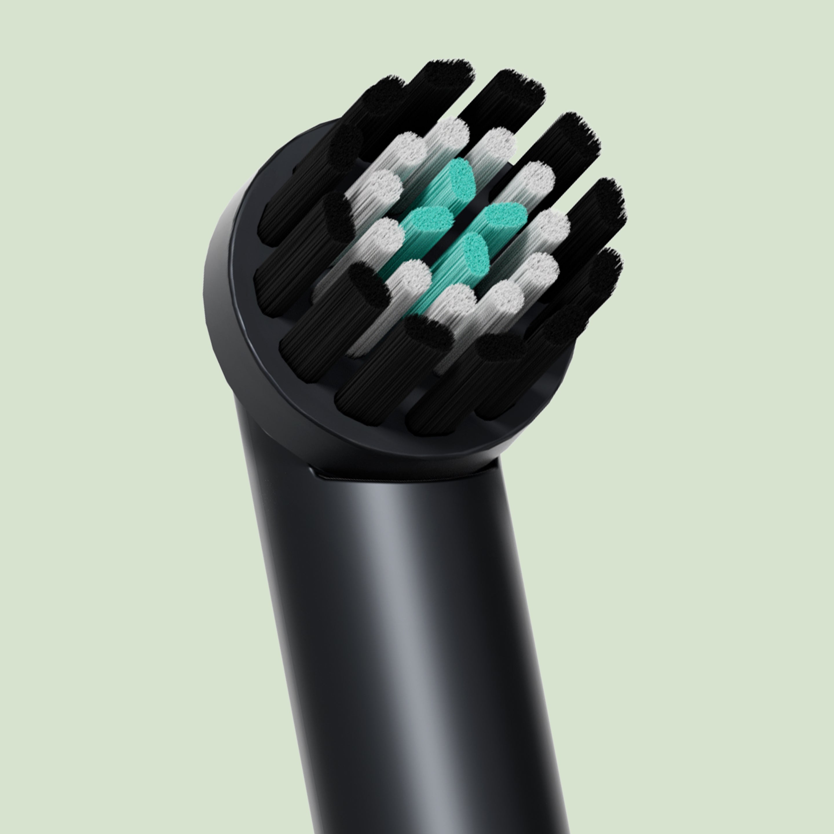 A very close-up detail shot of a black quip Rev brush head refill, showing the black and white bristles with a cluster of bright teal indicator bristles in the center.
