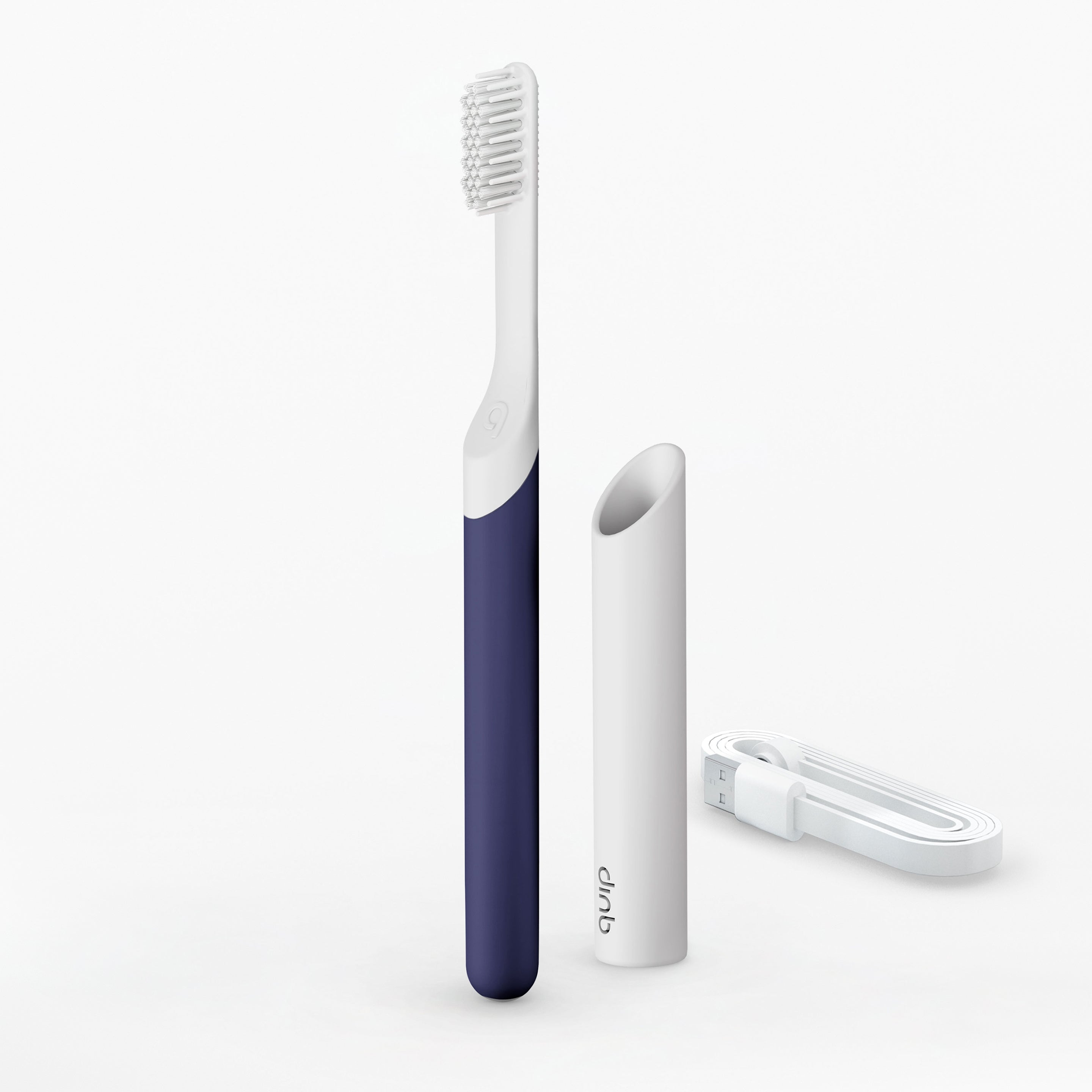 A rechargeable sonic toothbrush with a navy blue handle, white soft-bristle brush head, and a white magnetic USB-A cable. A slim plastic handle and a travel cover are also visible.