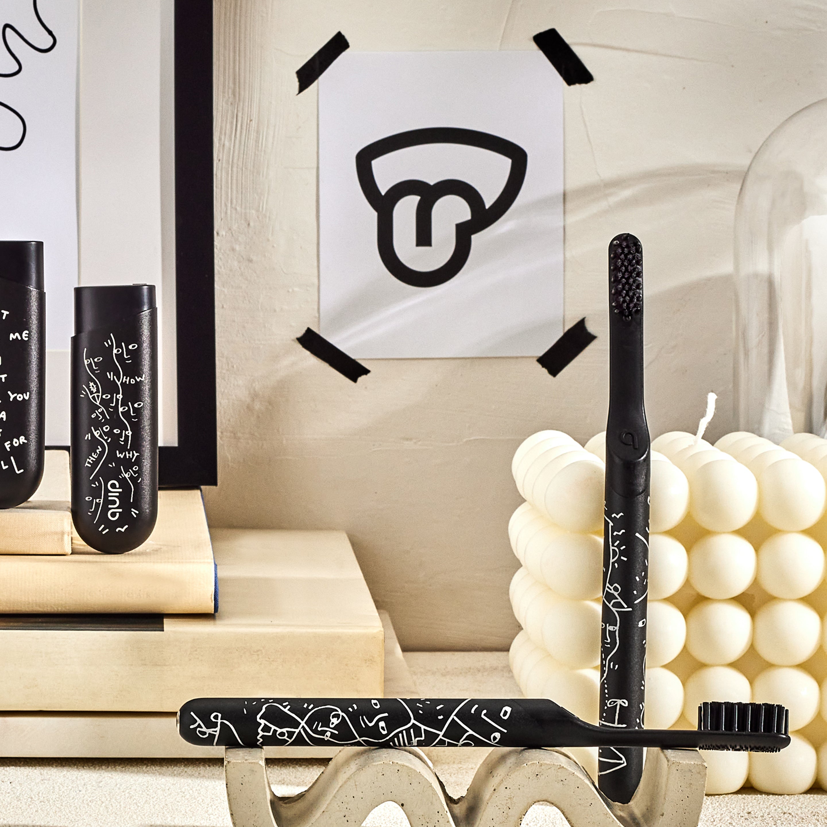 A smart rechargeable sonic toothbrush with a black handle and a geometric pattern, accompanied by a mint dispenser.