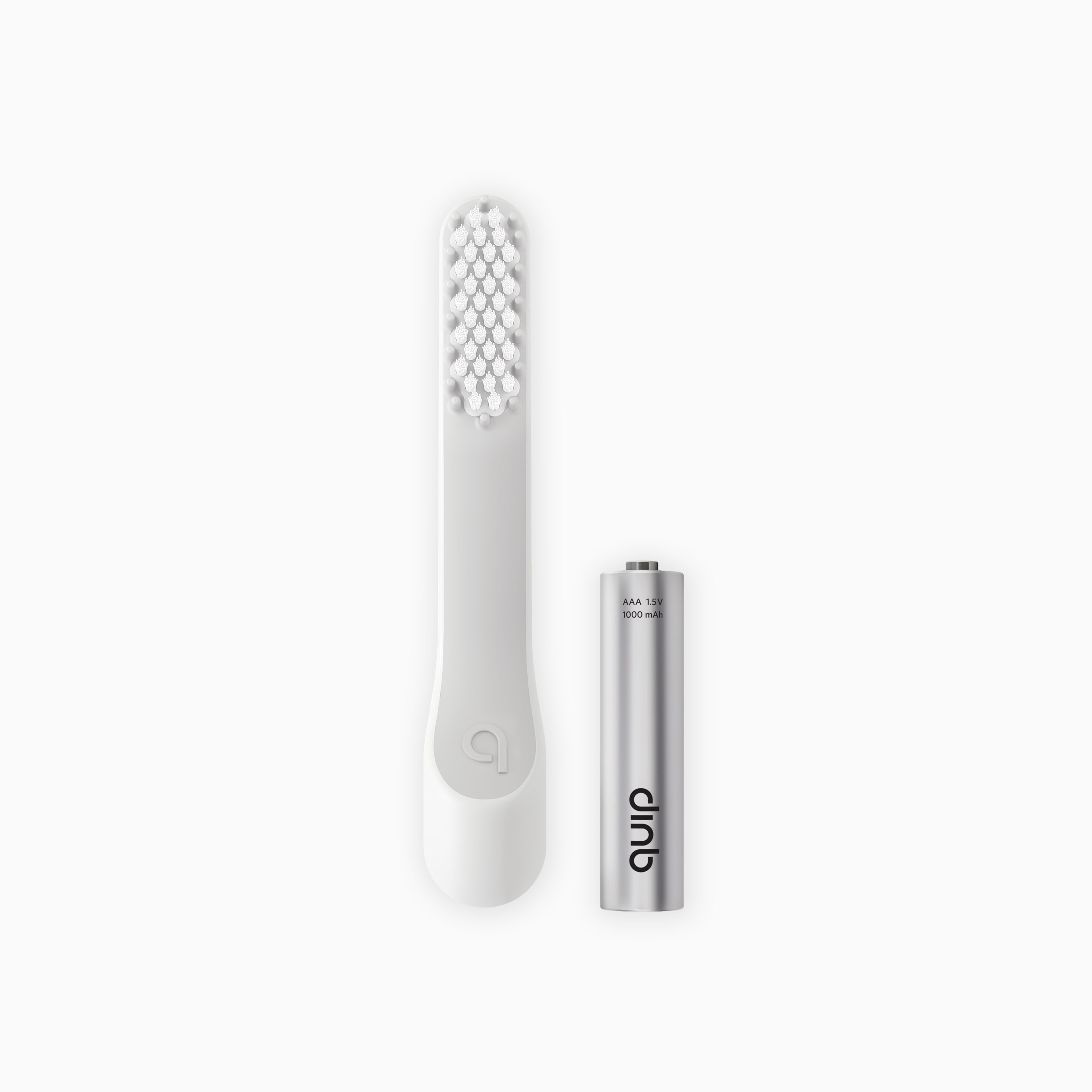 An image showing a white toothbrush head refill with soft bristles and a tongue scraper, accompanied by a AAA battery.