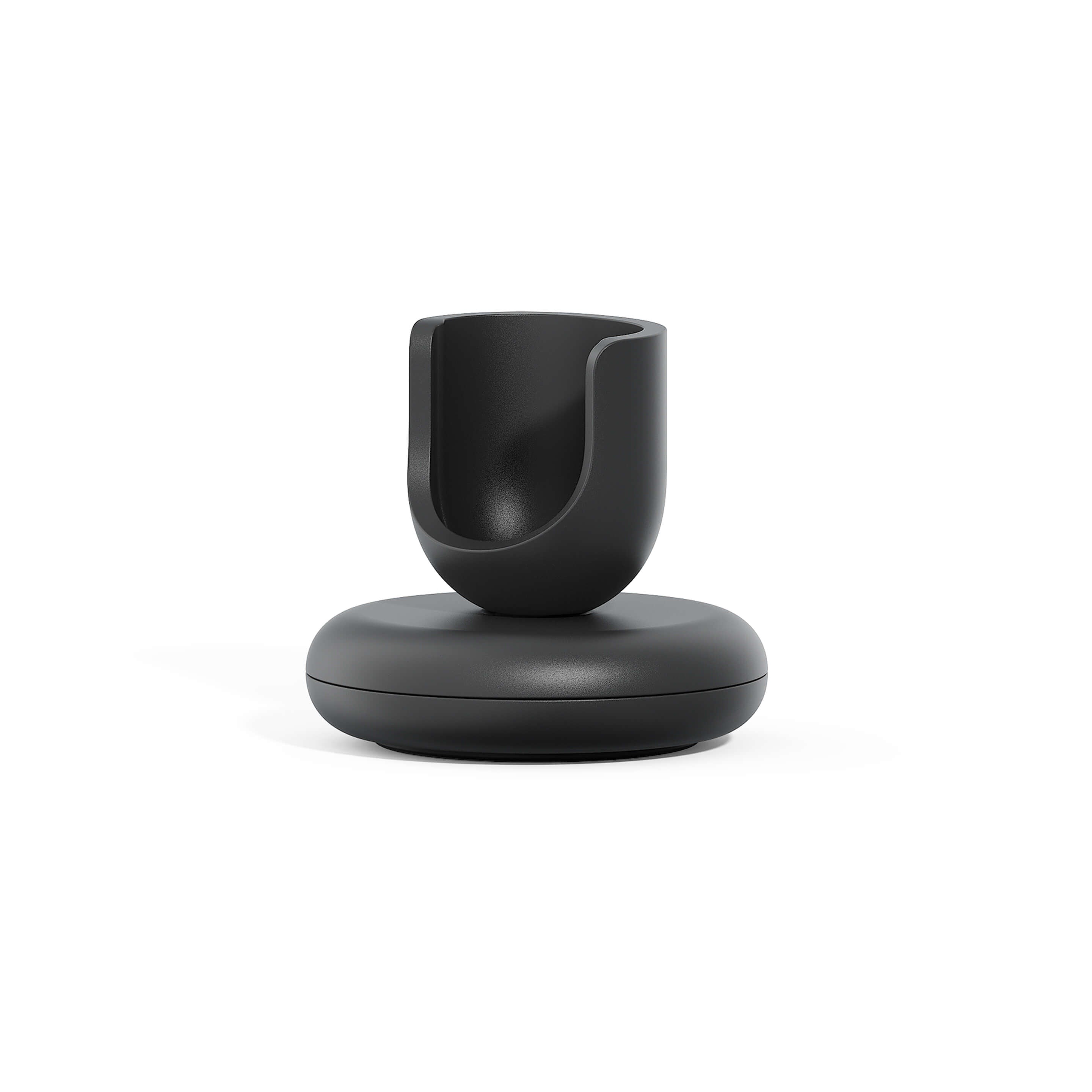 A black toothbrush stand with a weighted base and a rubber ring for traction, designed to hold a quip Ultra Smart Sonic Toothbrush upright.