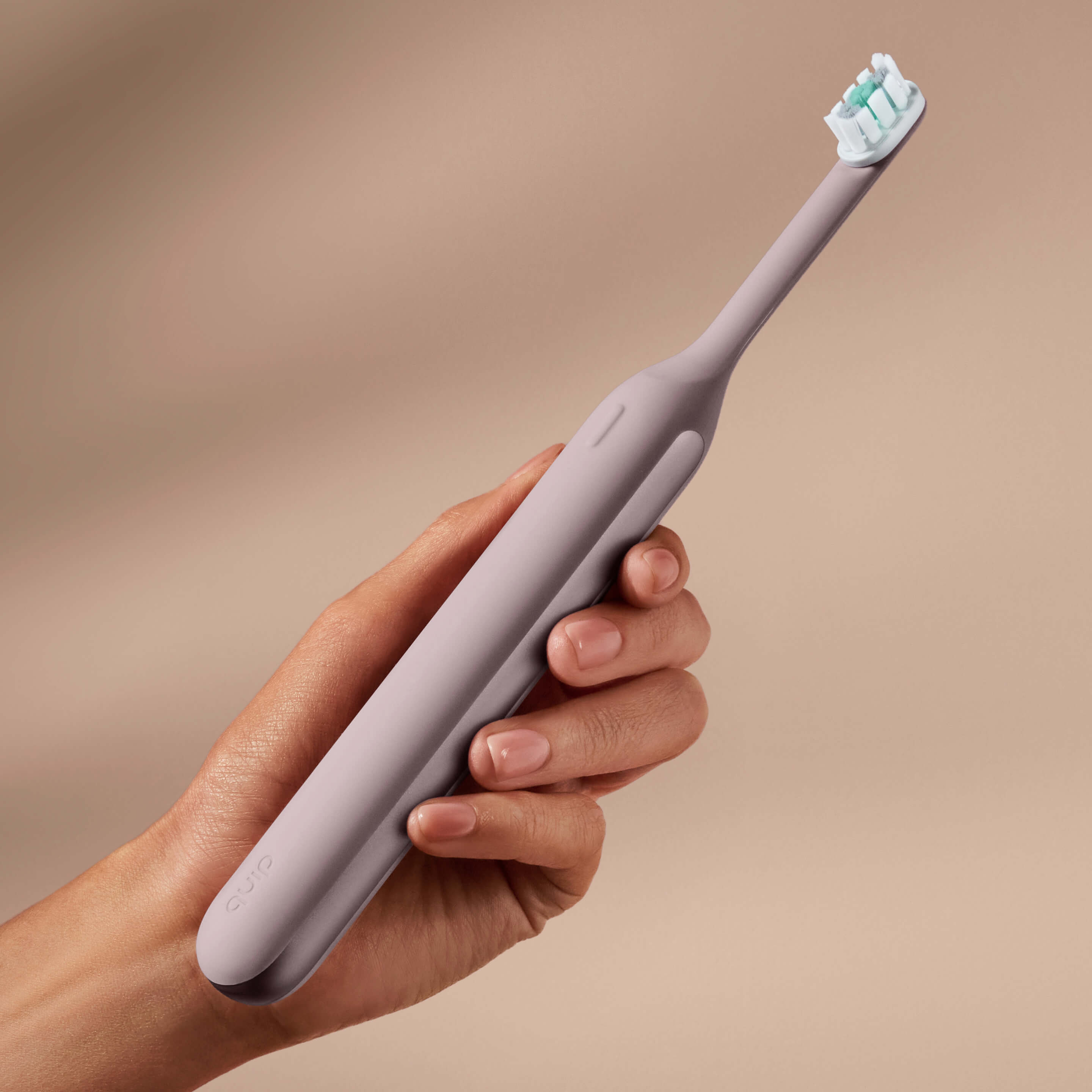 Hand holding the Ultra™ Next Generation Smart Sonic Electric Toothbrush in Dusk color.