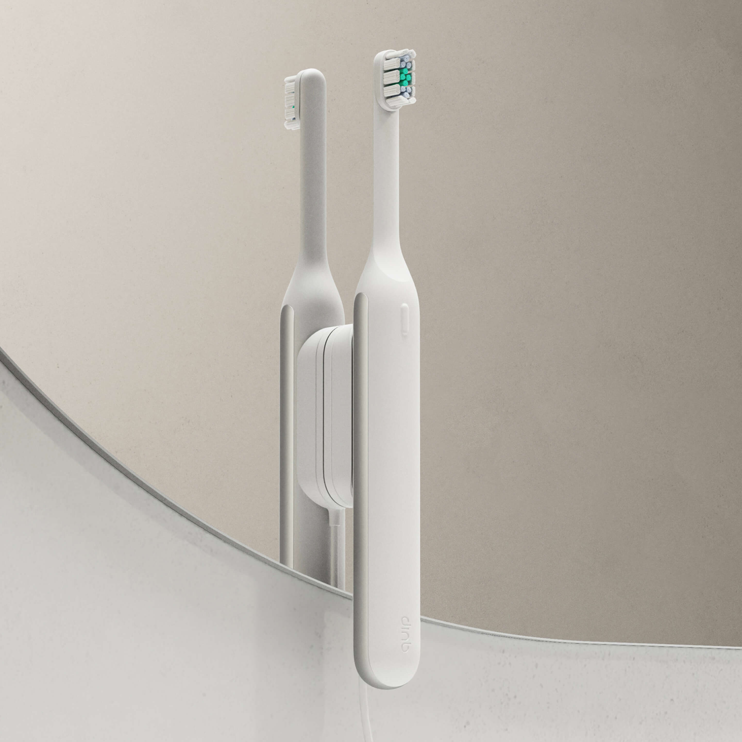 Ultra™ Smart Sonic Electric Toothbrush in Stone mounted on a bathroom mirror.
