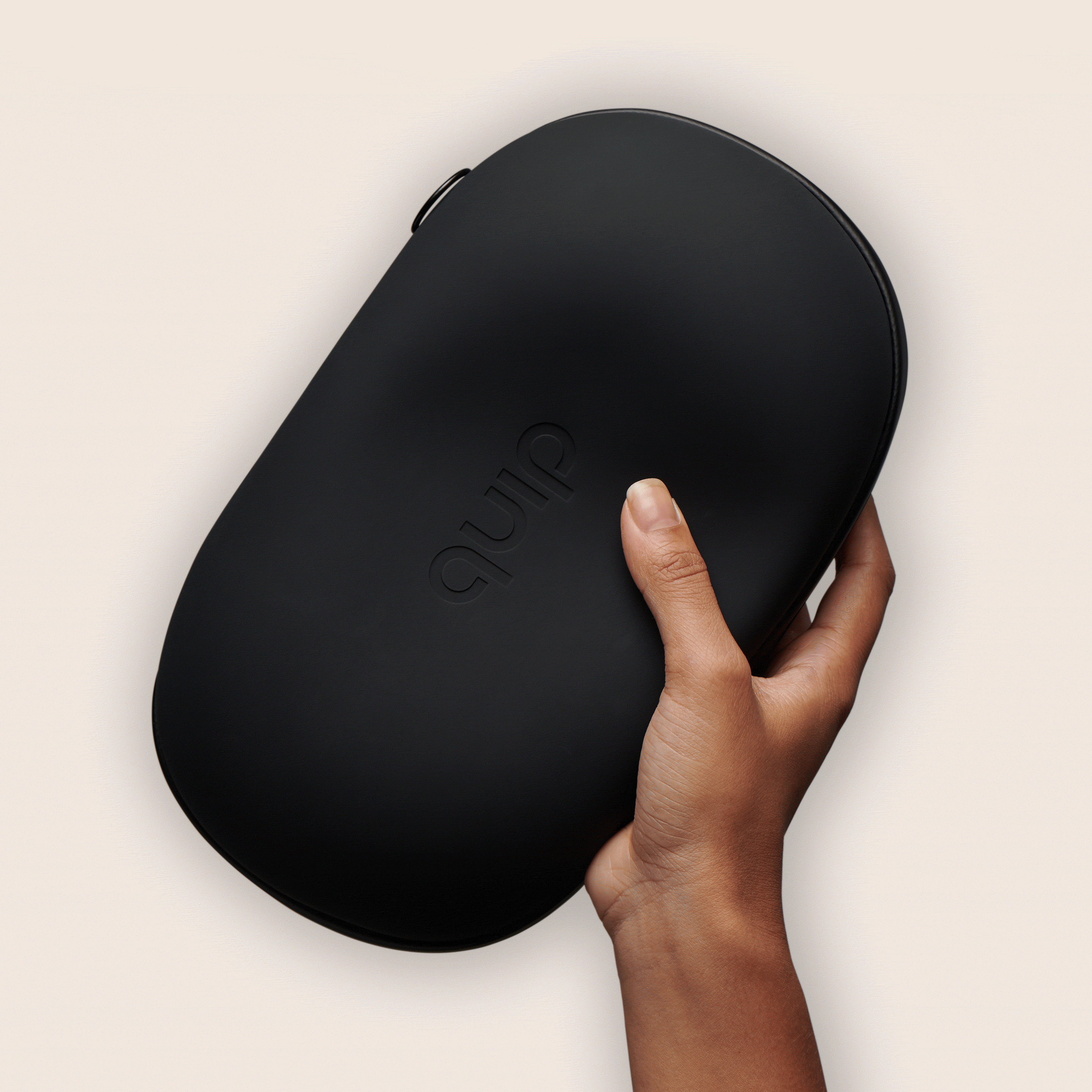 a hand model holds the green quip refresh bag, featuring the quip logo embossed on the front