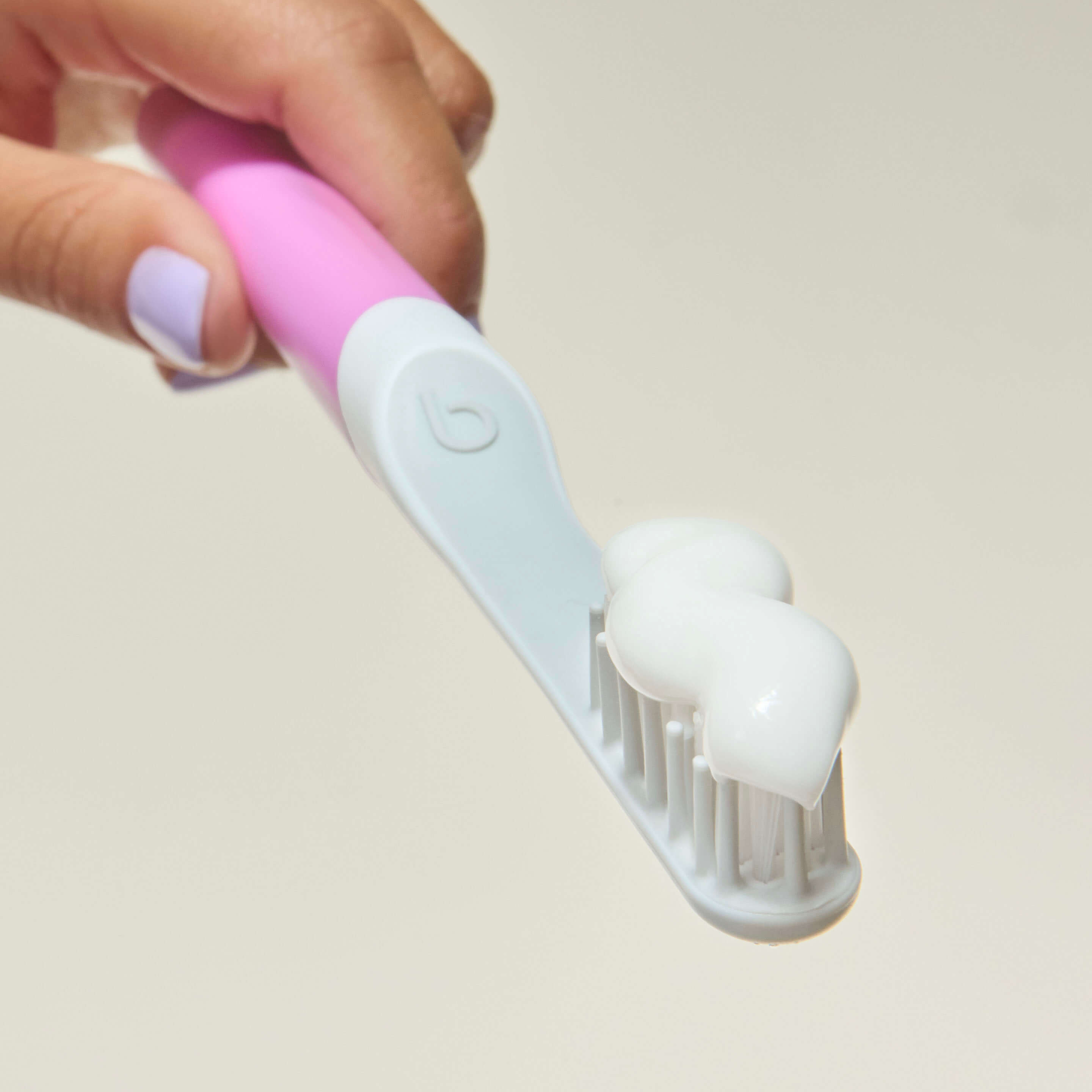 A sonic toothbrush with a white handle and a gray body next to its travel cover, against a white background.