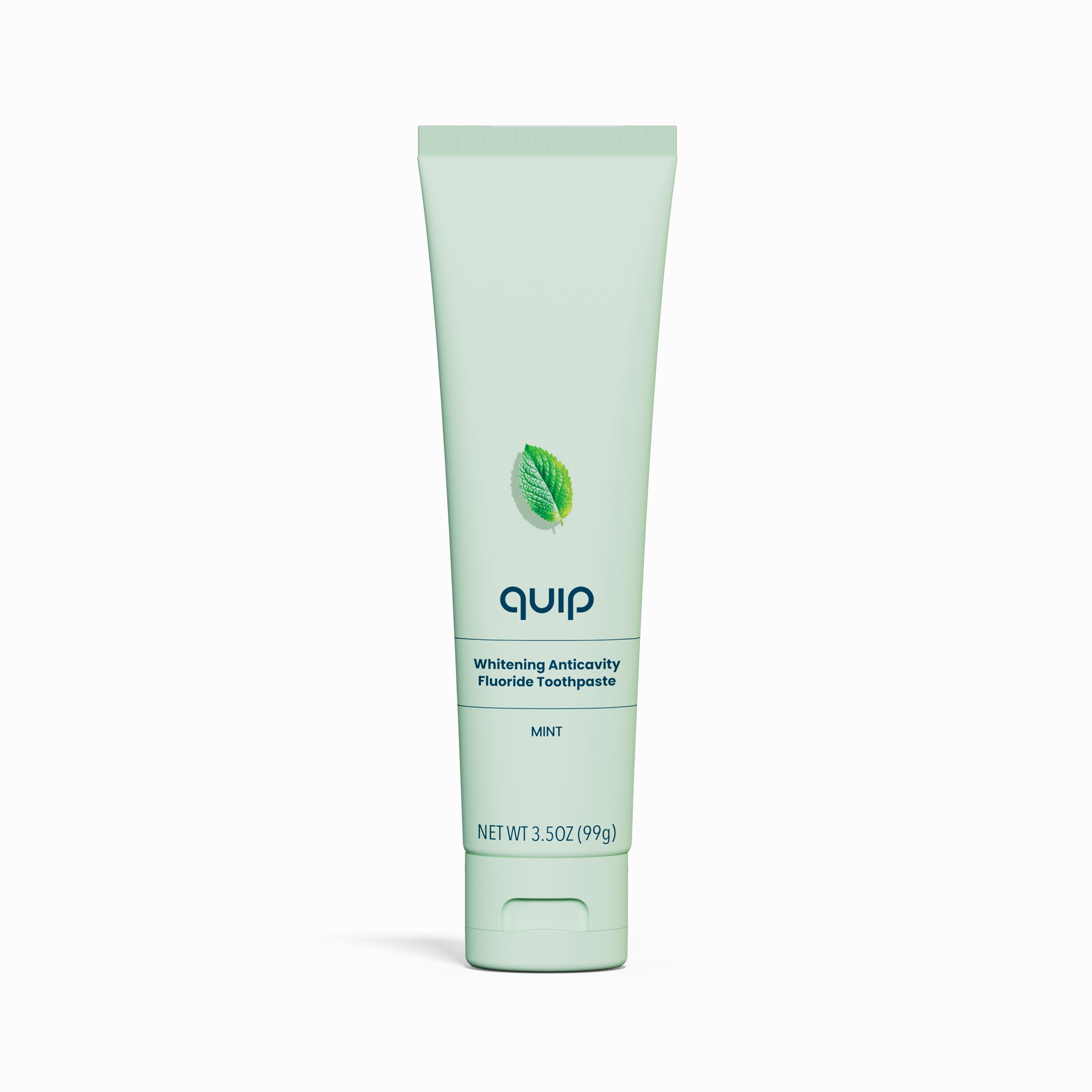 Green tube of quip toothpaste on a white background