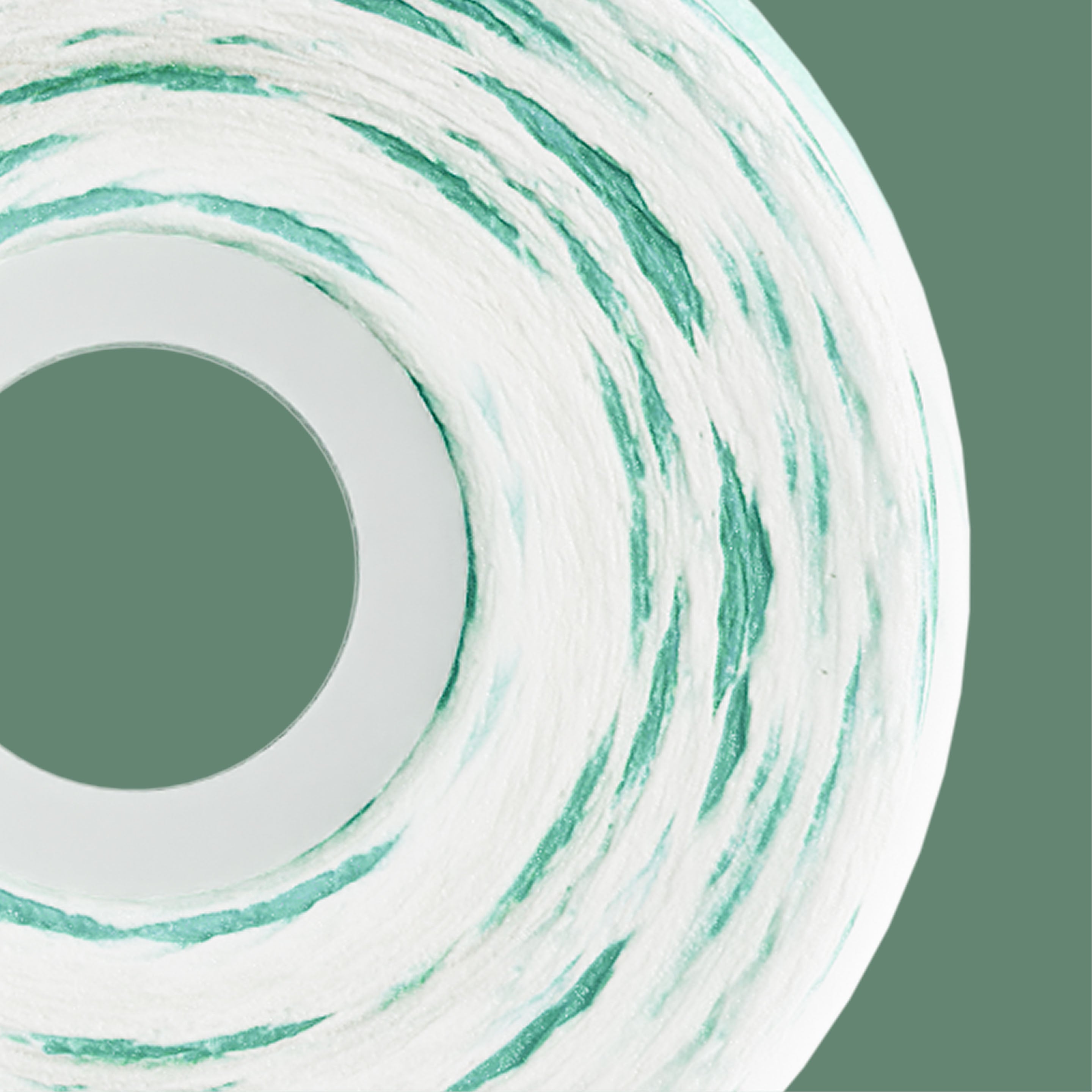 A close-up of a roll of wallpaper or contact paper featuring a textured white base with wavy mint green and teal stripes, set against a solid sage green background.