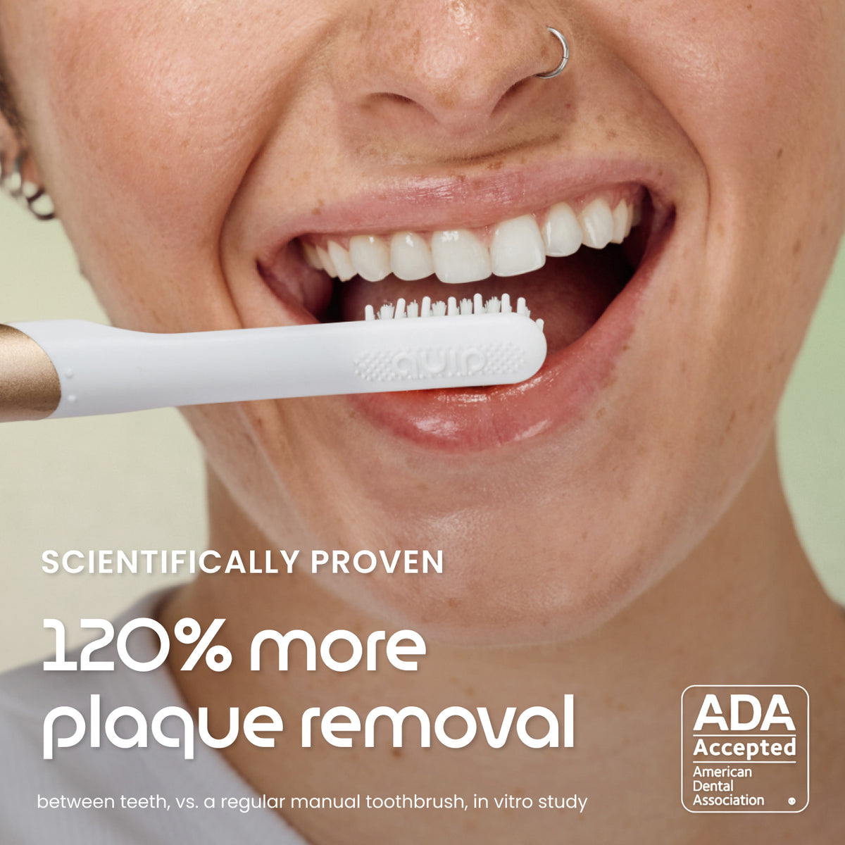 Close-up of a person brushing their teeth with a white and gold electric toothbrush, with text reading 'SCIENTIFICALLY PROVEN 120% more plaque removal' and an ADA Accepted badge.