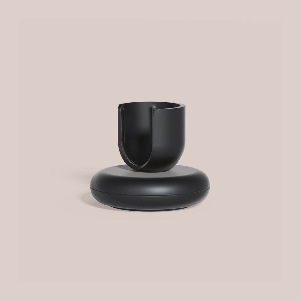 Black Rev toothbrush stand with a rounded base.