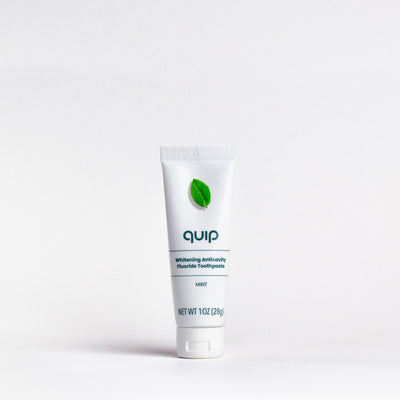 Tube of 'quip' toothpaste on a white background