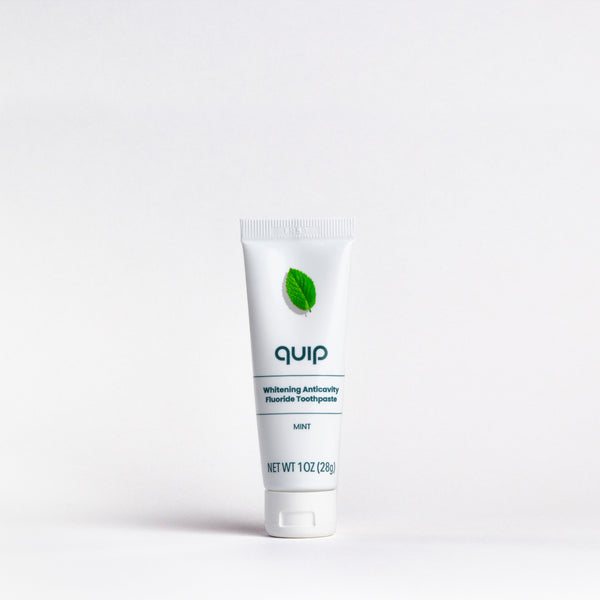 Tube of 'quip' toothpaste on a white background