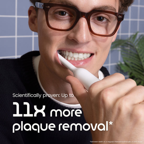 Person brushing teeth with a toothbrush, with text about plaque removal.