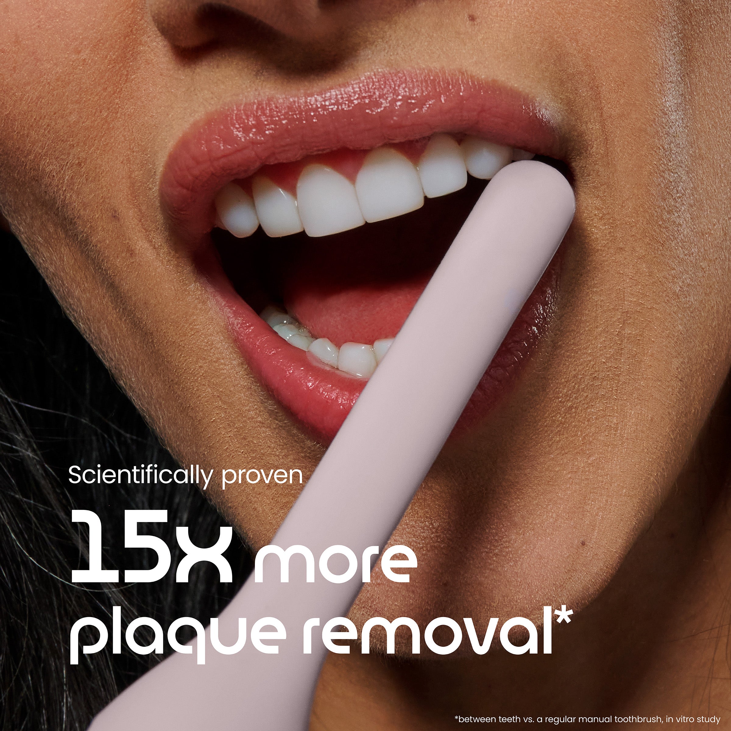 Close-up of a person using a toothbrush with text about plaque removal.