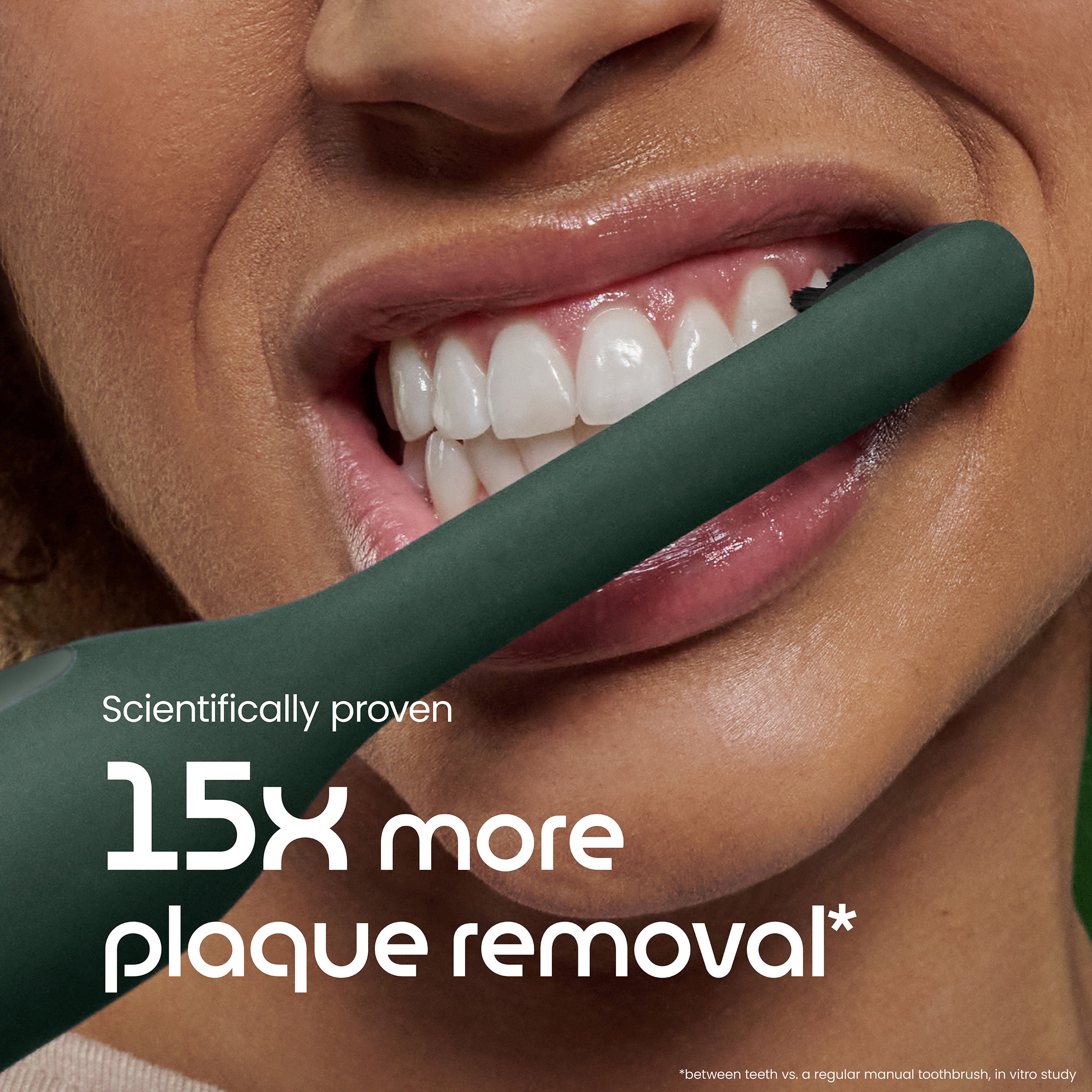 Teeth with a green toothbrush and text about plaque removal