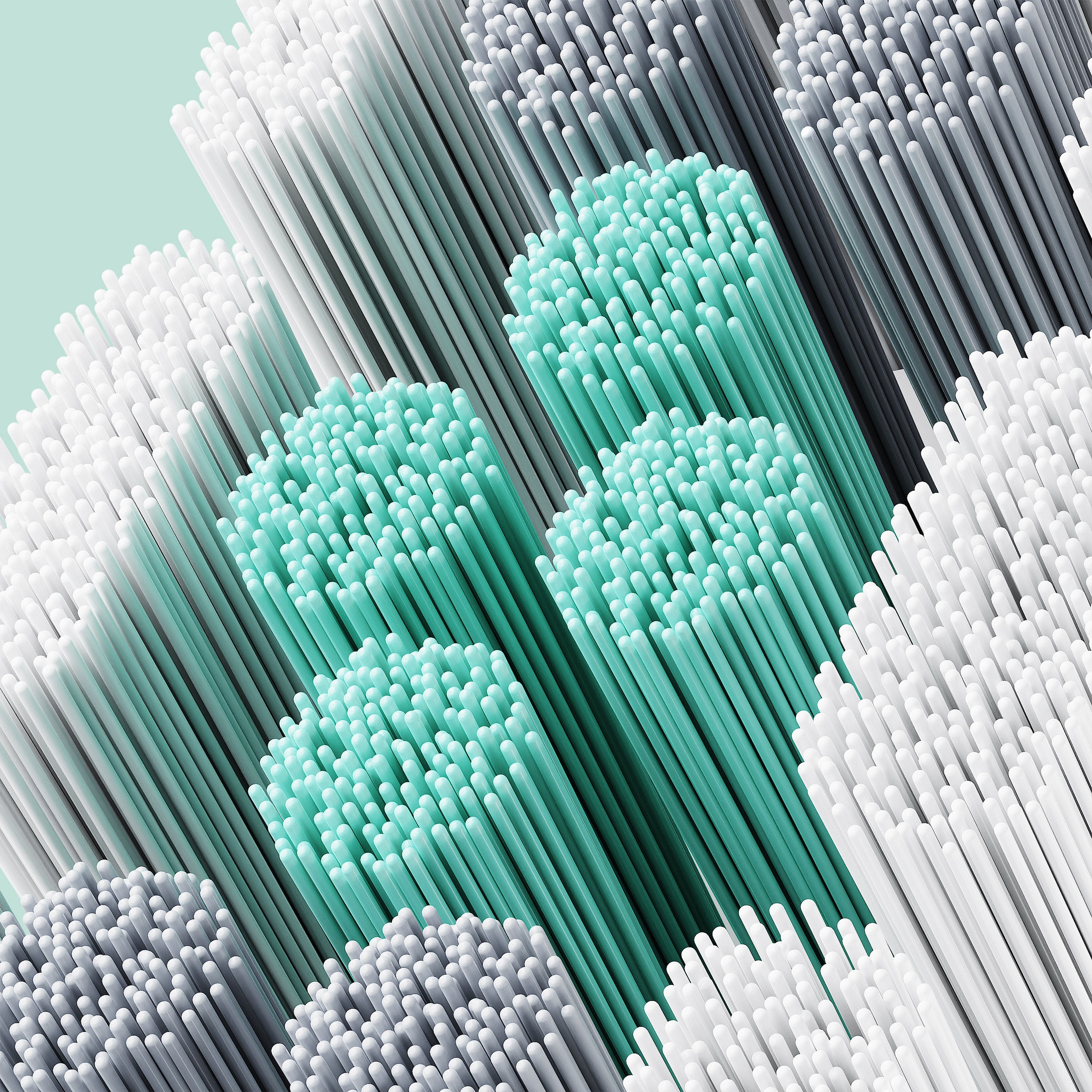Close-up of colorful straws arranged in a pattern on a light blue background