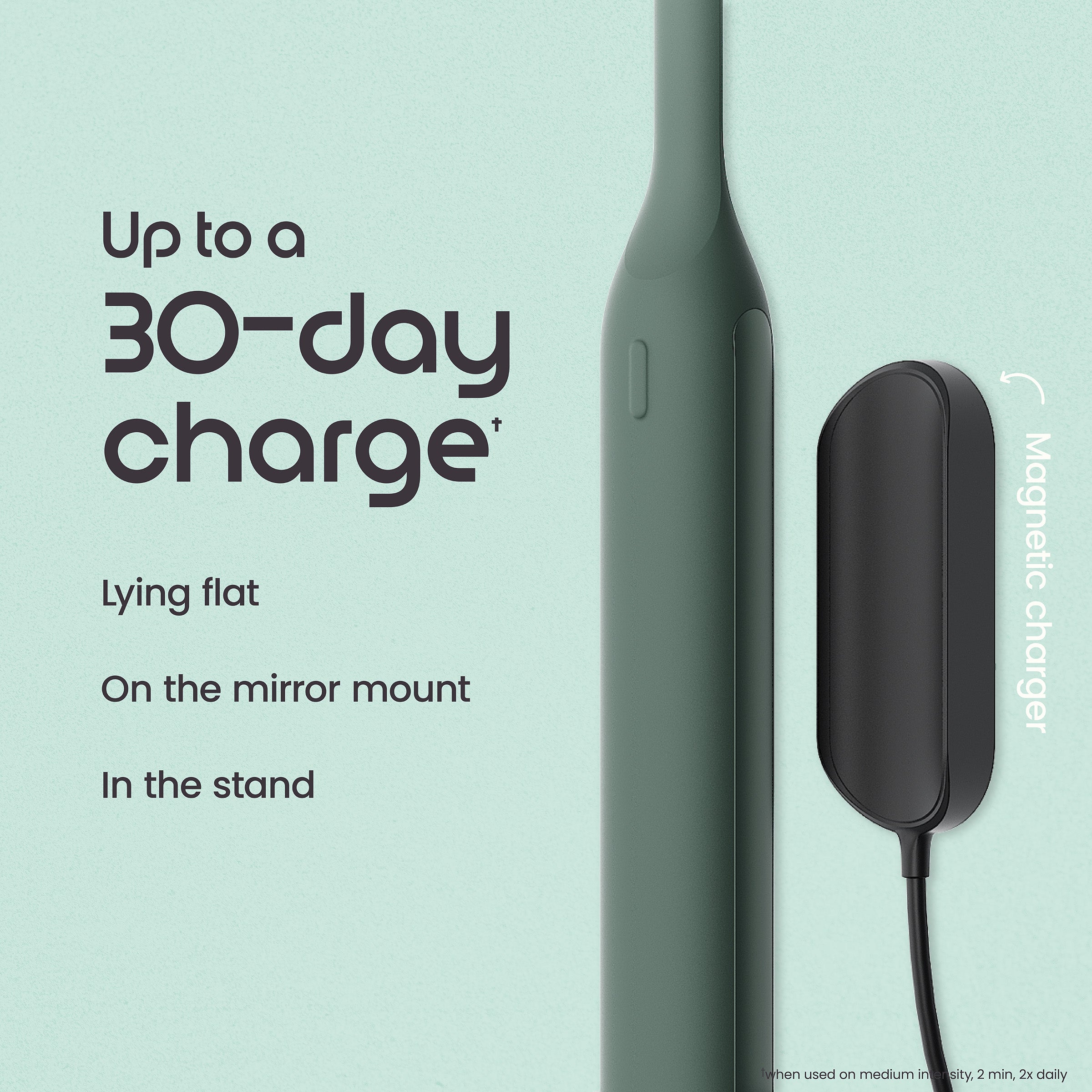 Green electronic device with magnetic charger on a light blue background