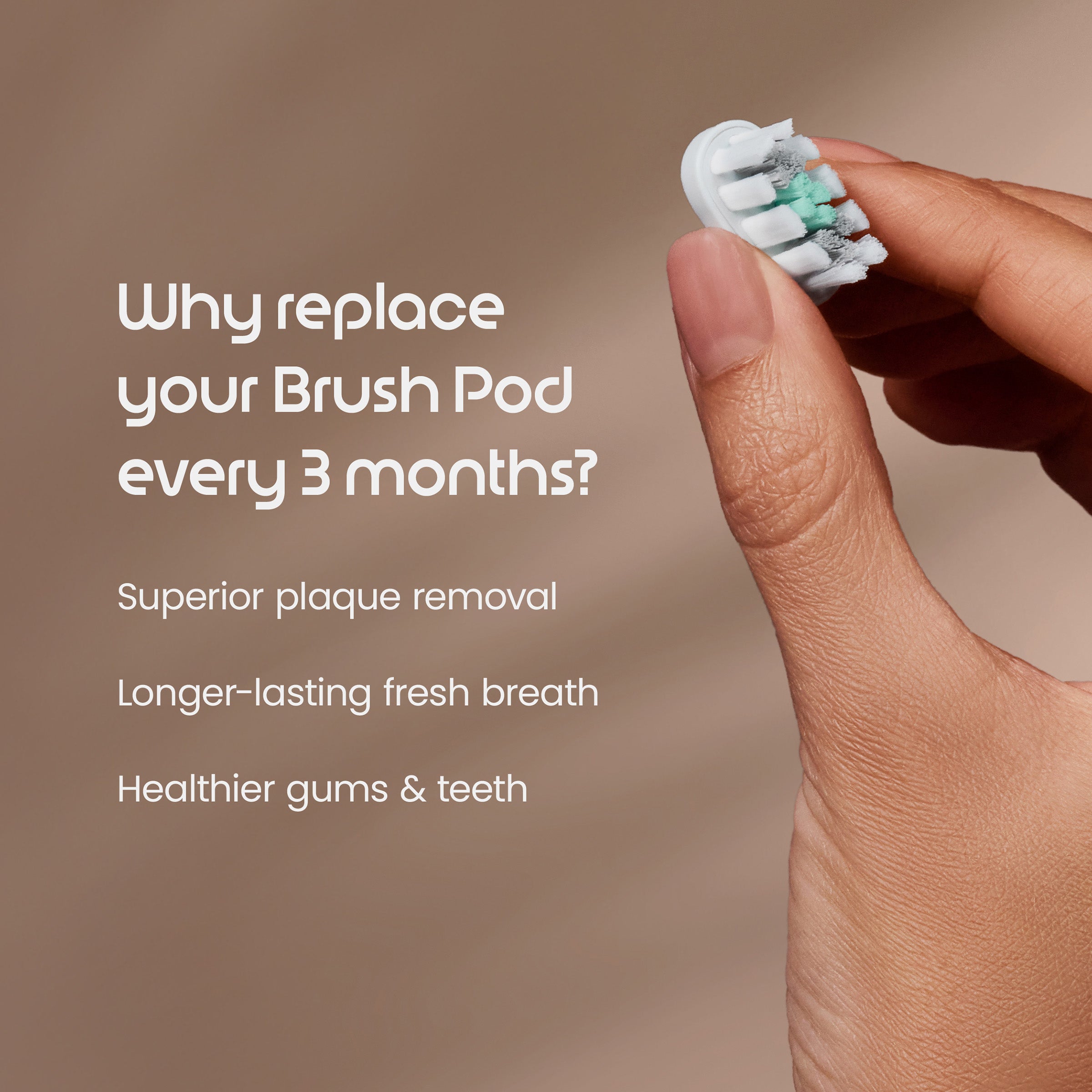 Hand holding a toothbrush head with text about replacing brush pods on a brown background