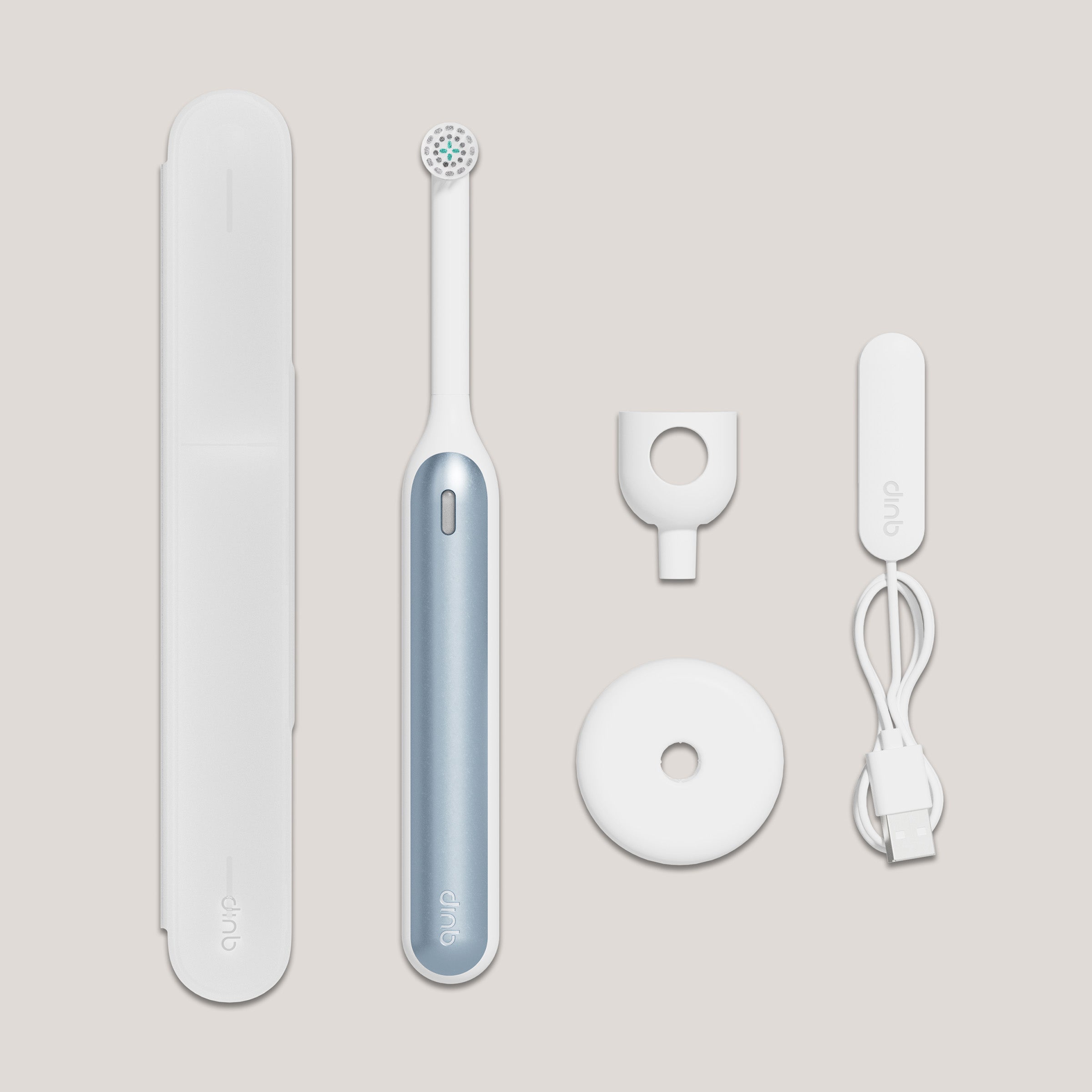 Electric toothbrush set with packaging, brush head, and charging cable on a light beige background