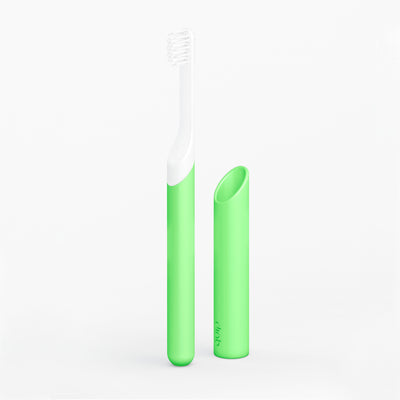 A kids' sonic toothbrush with a glowing green handle and a small soft-bristle brush head, accompanied by a radiant green travel cover.