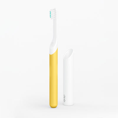 A kids sonic toothbrush with a yellow handle and white brush head, displayed alongside its travel cover/mount.