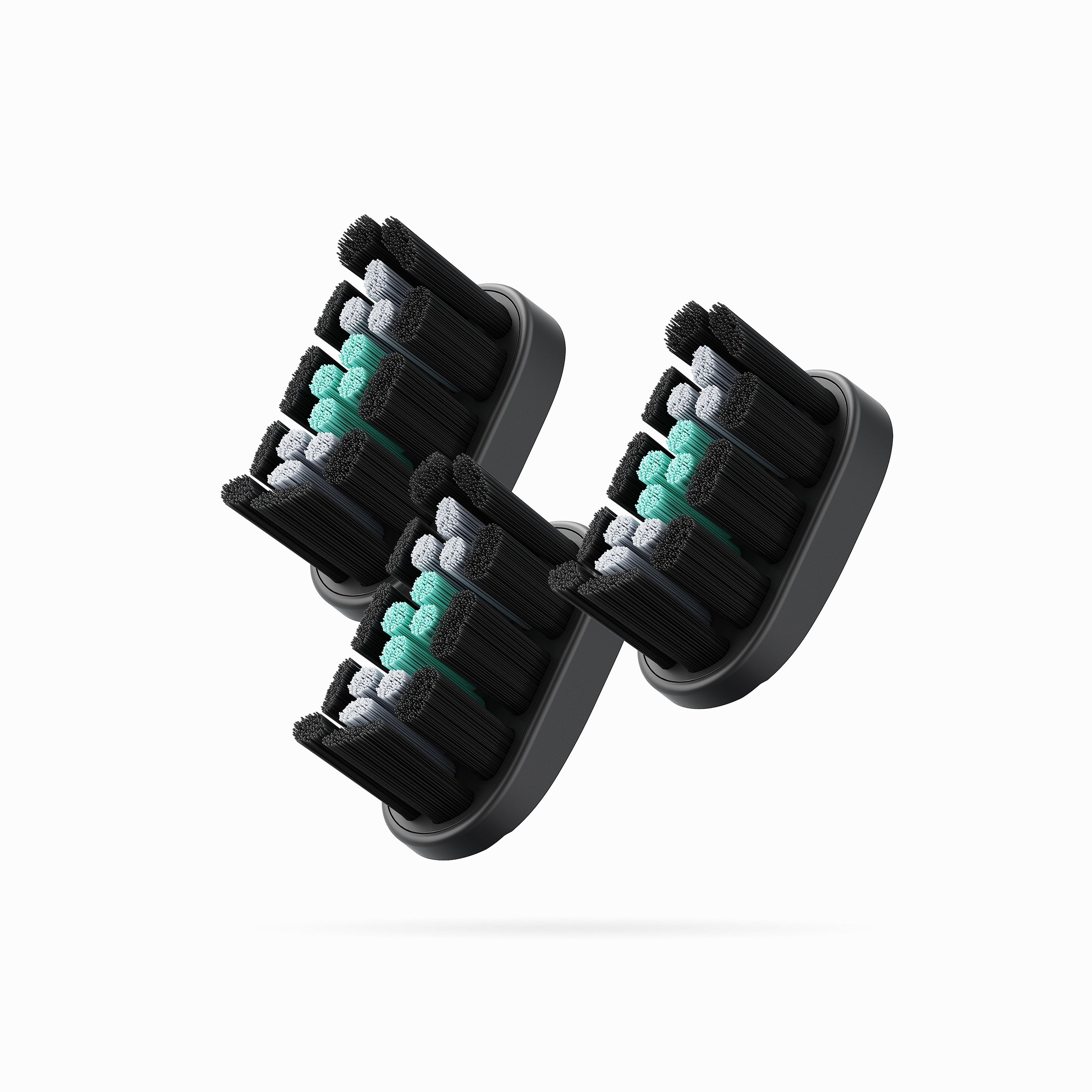 Three black and gray toothbrush heads with green bristle tips on a white background