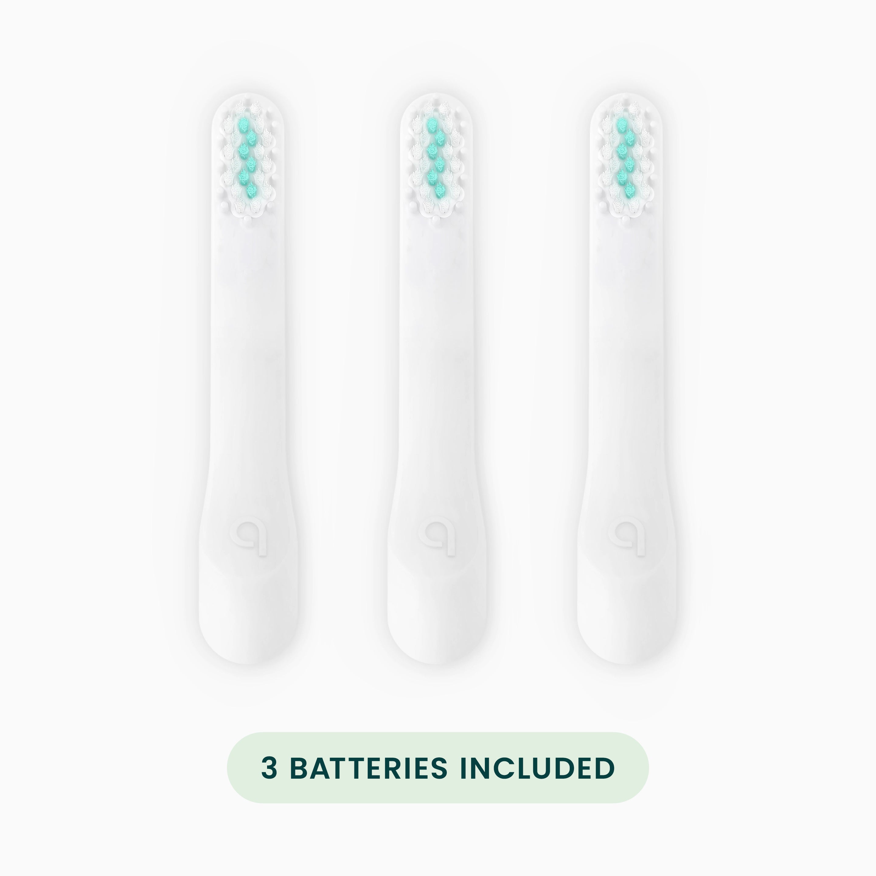 Three toothbrush heads with batteries included on a white background