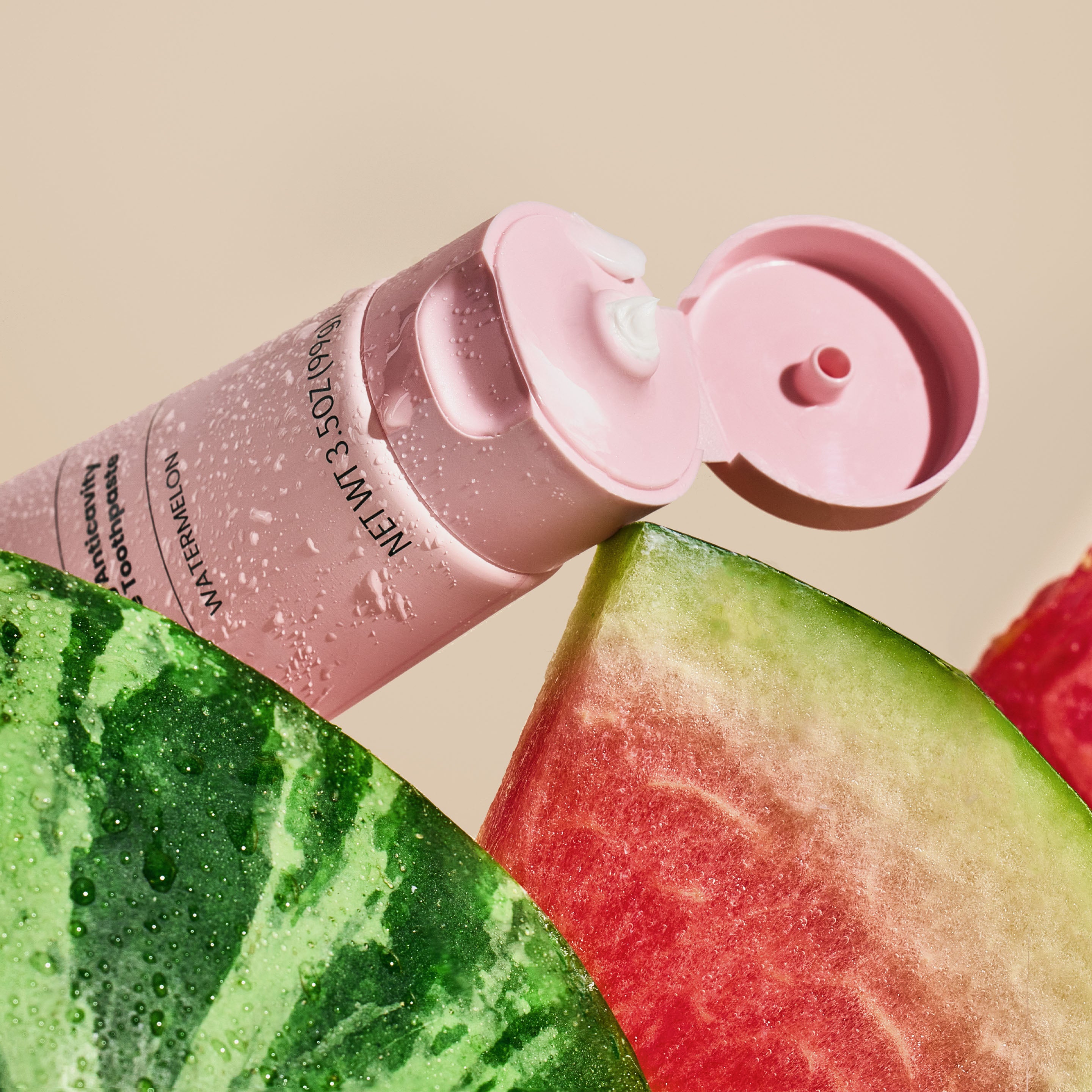 Pink water bottle with a watermelon slice on a beige background