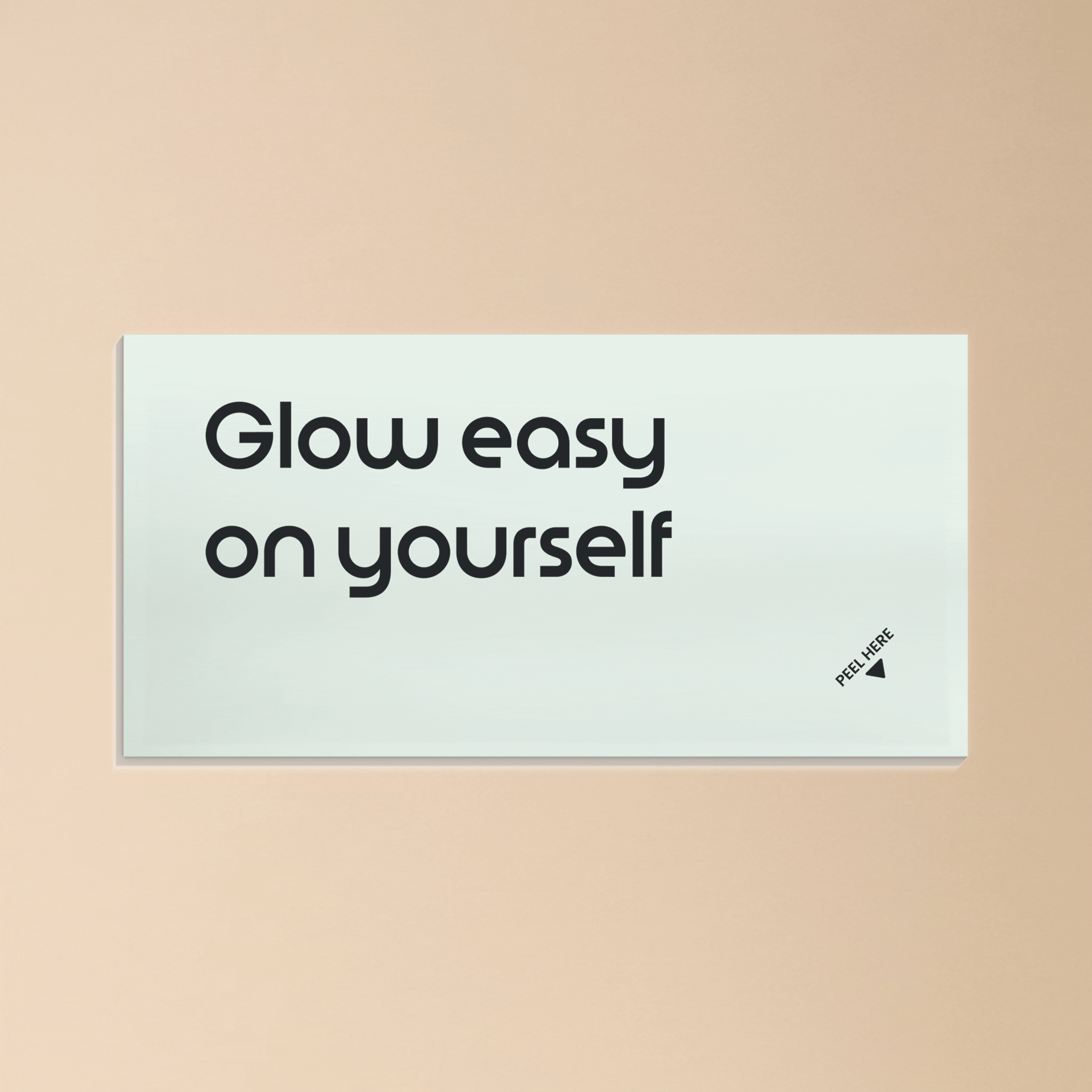 Light card with the text ‘Glow easy on yourself’ against a soft beige background.