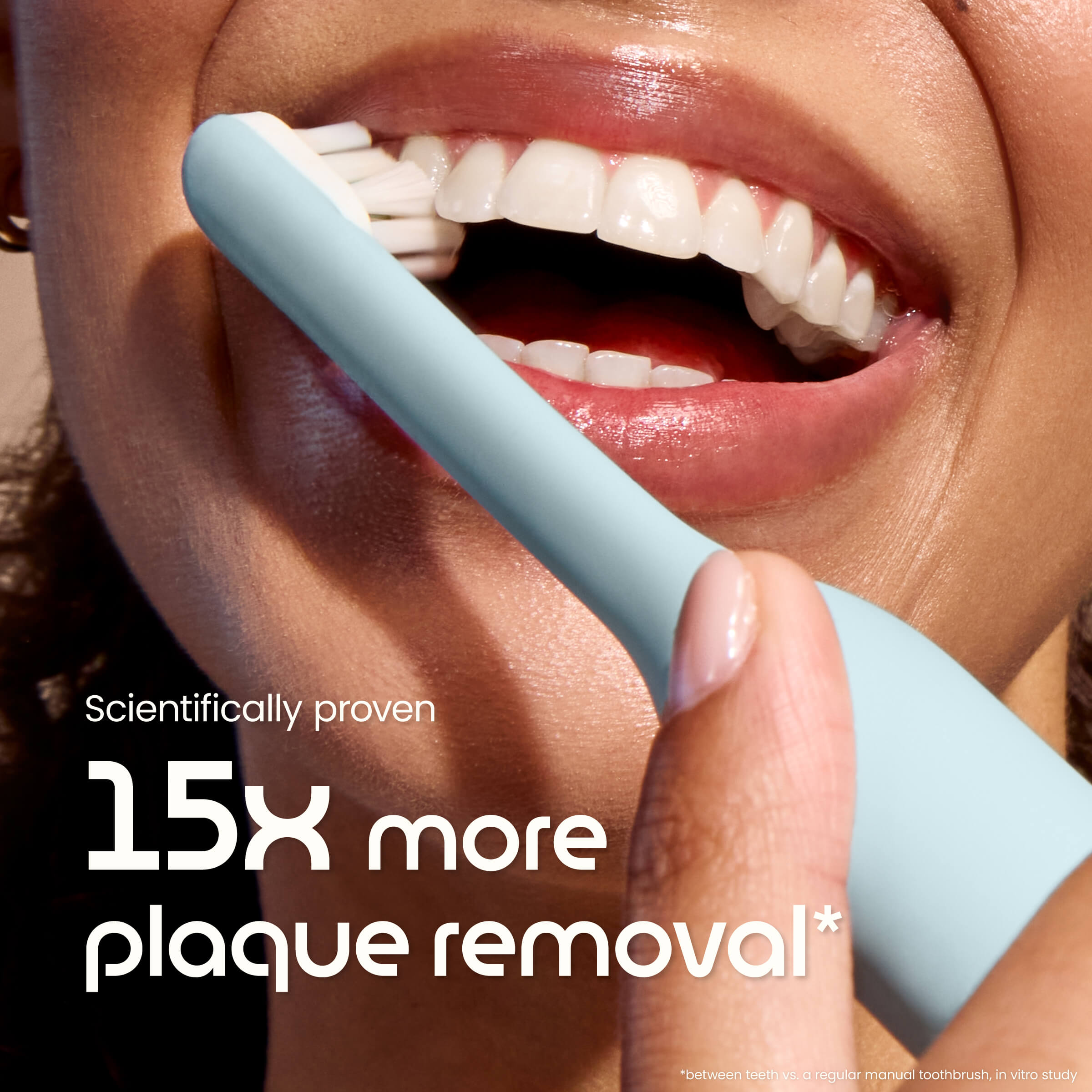 Close-up of a person brushing their teeth with a blue toothbrush, emphasizing plaque removal benefits.