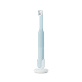 Electric toothbrush with a stand on a white background