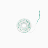 A roll of white cord or twine with a thin mint green stripe running along the outer layer, shown on a clean white background.