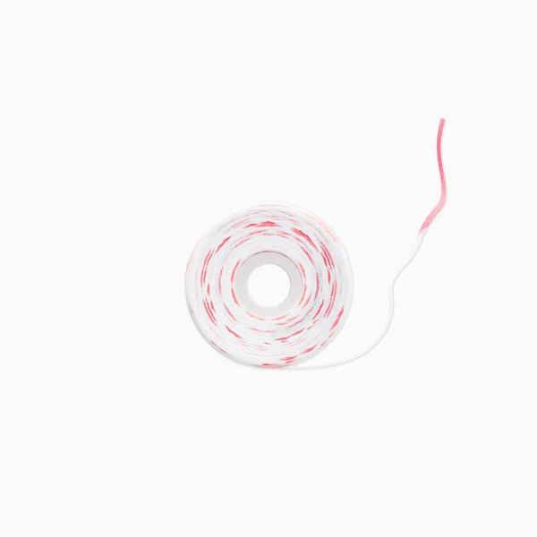 A roll of white adhesive tape with a red stripe pattern, shown on a clean white background.