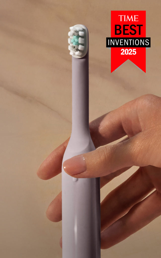 Quip Ultra Smart Sonic Toothbrushes in multiple colors standing upright, with a hand reaching for one and a TIME Best Inventions 2025 award badge displayed.
