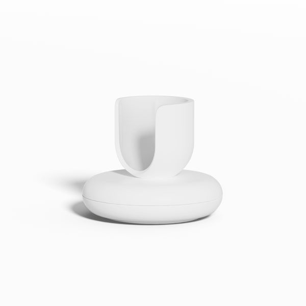 White Rev Stand featuring a rounded base and an open, U-shaped holder for supporting a toothbrush, shown against a clean white background.