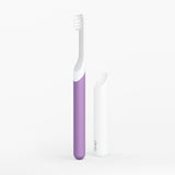 Purple and white toothbrush on a light gray background